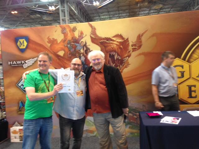 Chaosium receiving the Uk Games Expo Best RPG Award from the Sixth Doctor himself, Colin Baker