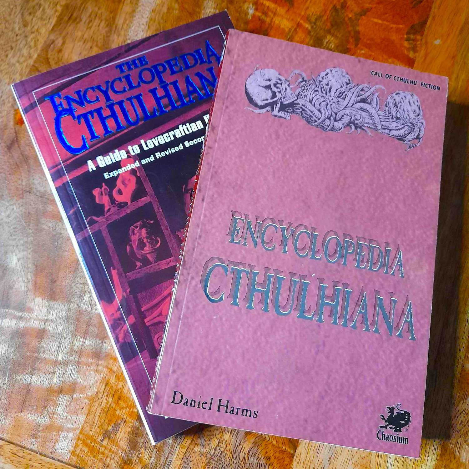 The two previous Chaosium editions of Encyclopedia Cthulhiana (front 1994 edition, back 2008 edition)